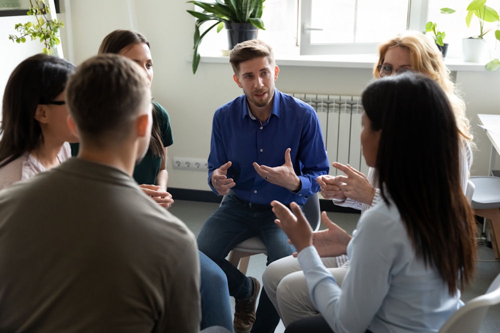 group of patients sitting in circle during meth addiction therapy