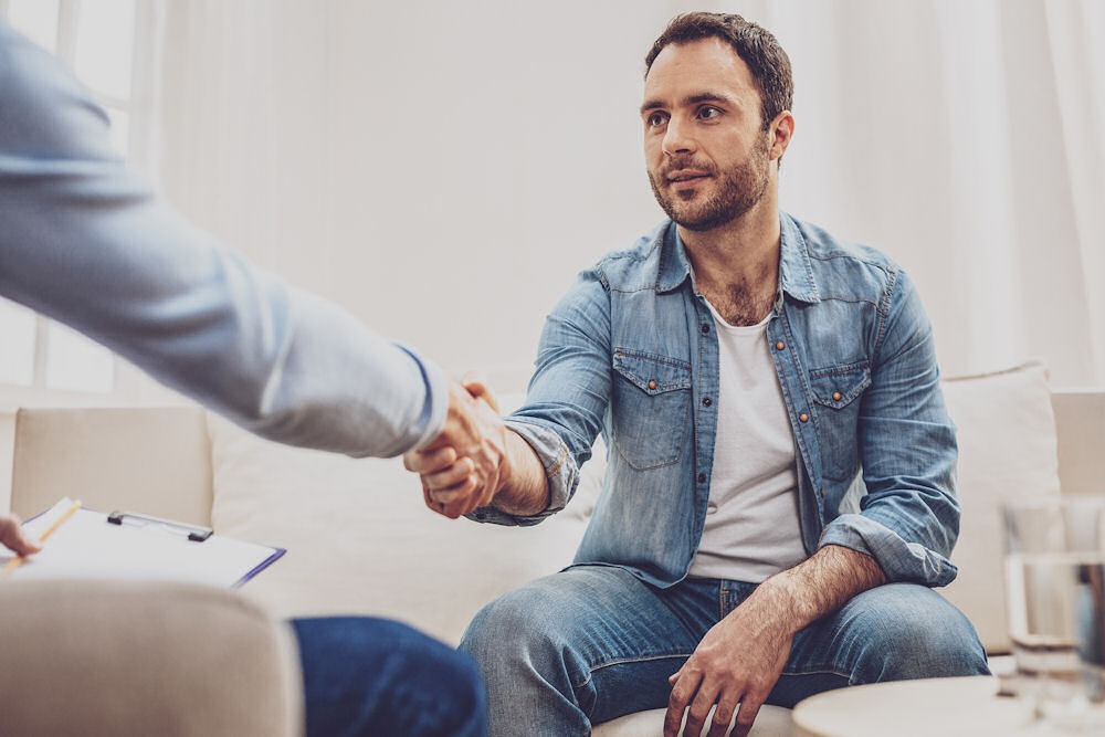 man shaking hands with healthcare provider during meth addiction treatment