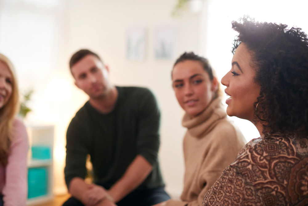 woman sharing during therapy